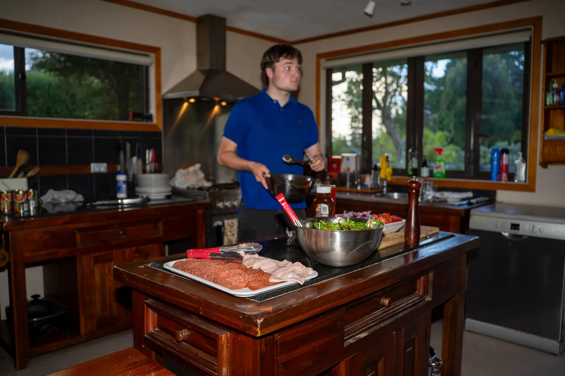 Person preparing pizza dough in a kitchen