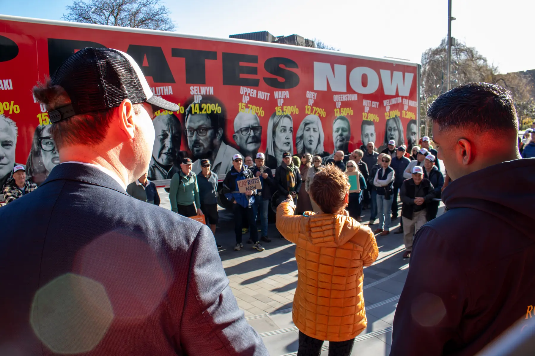 Crowd gathered in front of a CAP RATES NOW truck wrap